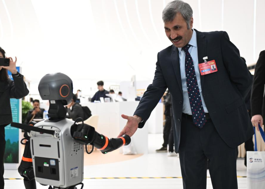 2025中關村論壇年會，與會嘉賓與機器人握手