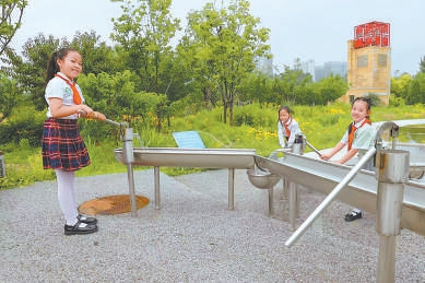 小朋友體驗(yàn)老式壓水井。